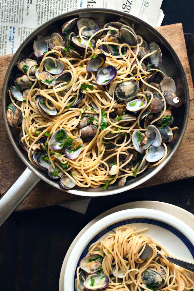 Spaghetti alle vongole served in a pan with parsley