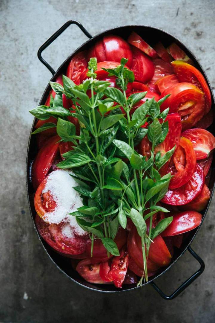 Fresh tomatoes and basil in a large pot | jernejkitchen.com