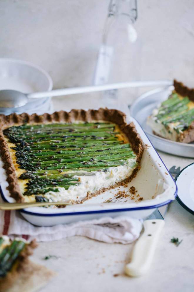 Super creamy Asparagus and Ricotta Tart served in a baking dish