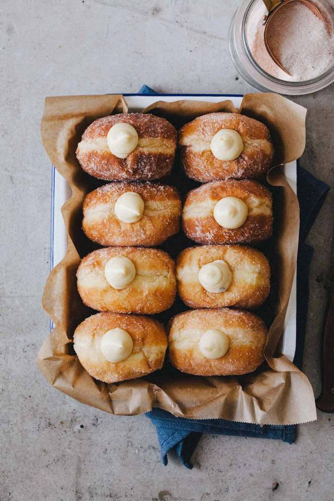 Soft Homamde Doughnuts with rich vanilla cream on a baking dish