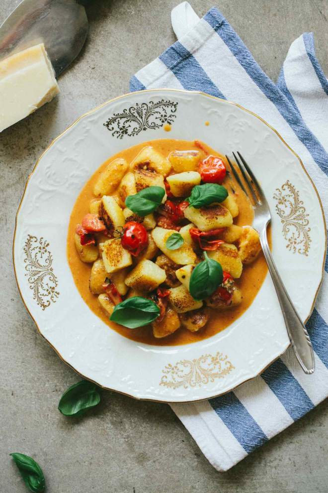 Gnocchi with Cherry Tomatoes served with basil on a plate