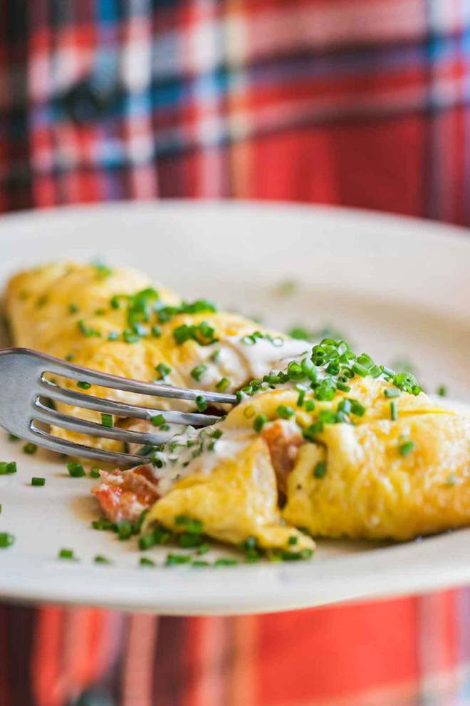 Omelette with Cherry Tomatoes on a Plate, served with sour cream and chives