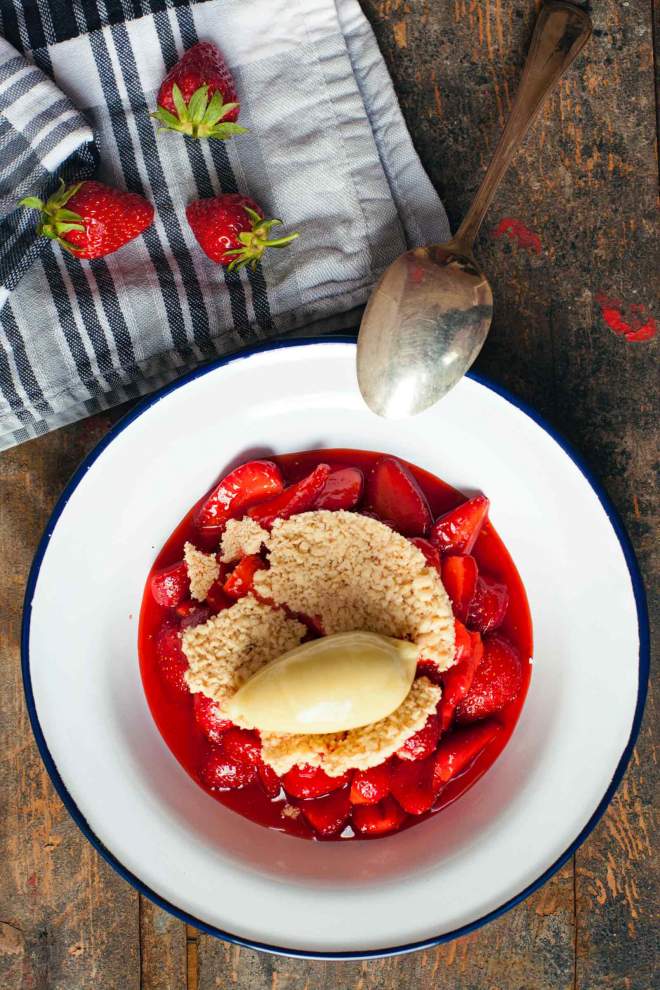 Strawberries with crumble and rhubarb sorbet served on a plate