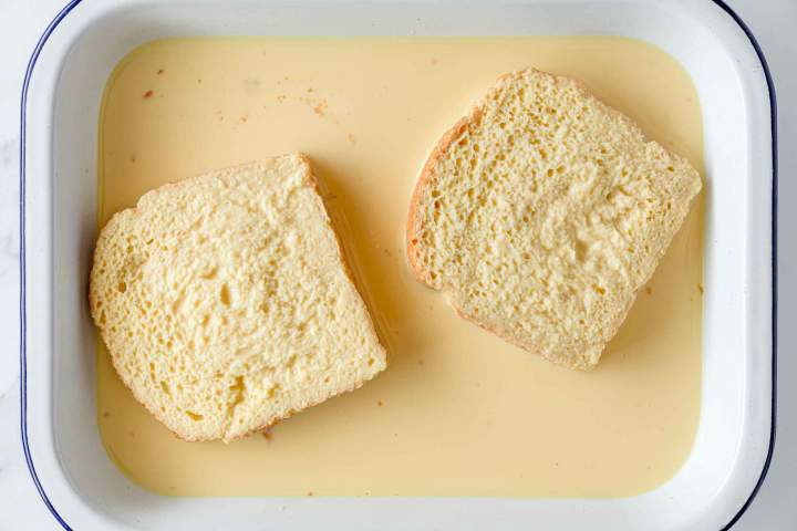 Dipping egg into egg mixture for Classic French Toast