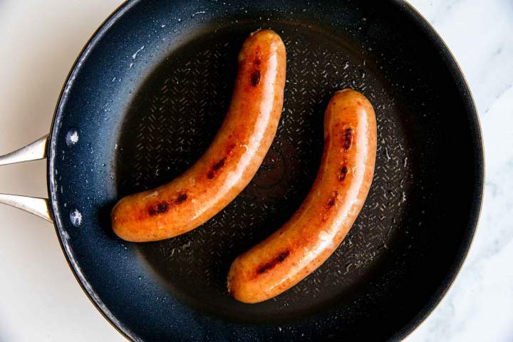 pan frying sausages for currywurst