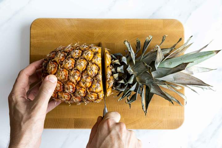Cutting a fresh pineapple for Pineapple sorbet