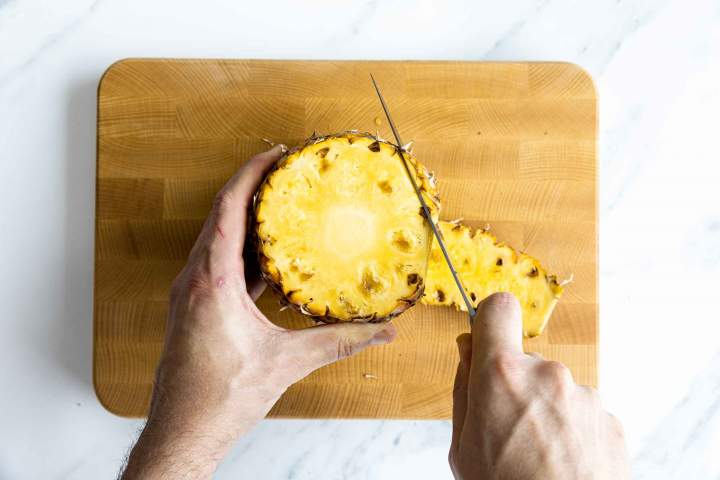 Cutting a fresh pineapple for Pineapple sorbet
