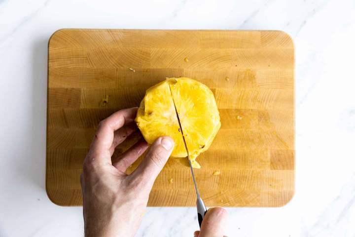 Cutting a fresh pineapple for Pineapple sorbet