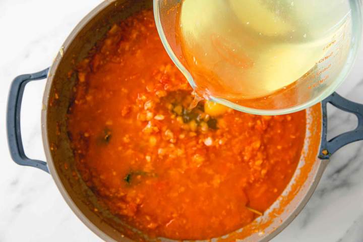 Pouring fish stalk into the Best Brodet (Fish Stew)