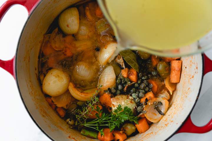 adding vegetable stock to Rabbit Stew