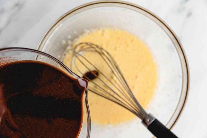 Adding chocolate to egg mixture Peanut Brownies with White Chocolate