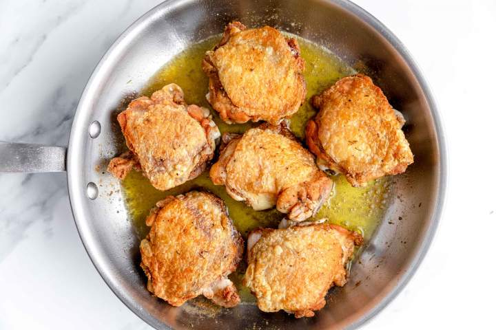 Pan-frying the meat for Oven-Baked Chicken Thighs with Carrots