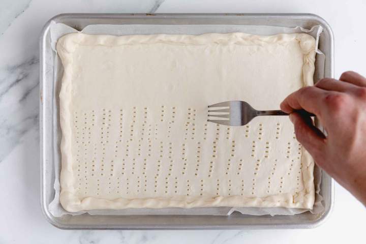 Preparing puff pastry for Asparagus Tart with Cream Cheese