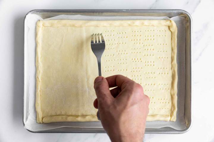 Pricking the puff pastry dough for Puff Pastry Tomato Tart with Mozzarella
