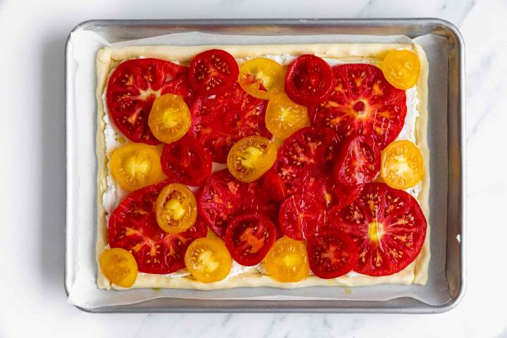 Arranging tomatoes on top of the ricotta filling