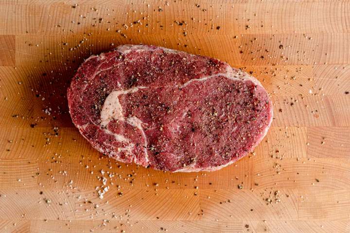 preparing the ribeye steak to grill