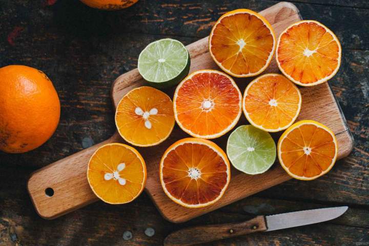 Fresh citrus cut in half on a wooden table