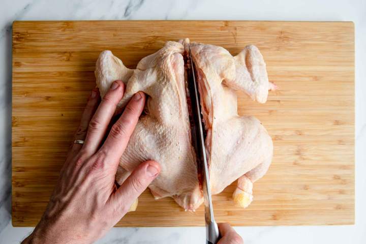 cutting whole chicken in half