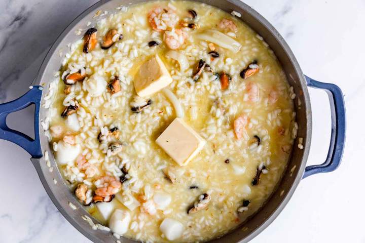 Adding butter to rice for Seafood Risotto