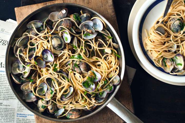 Spaghetti alle vongole served in a pan with parsley