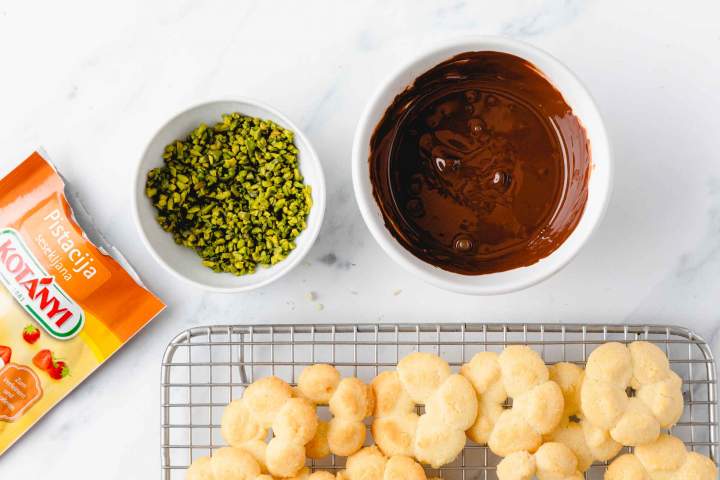 Dipping Spritz cookies in melted chocolate