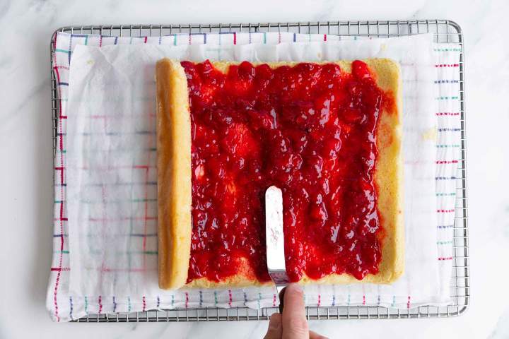 strawberry jam spread on sponge cake