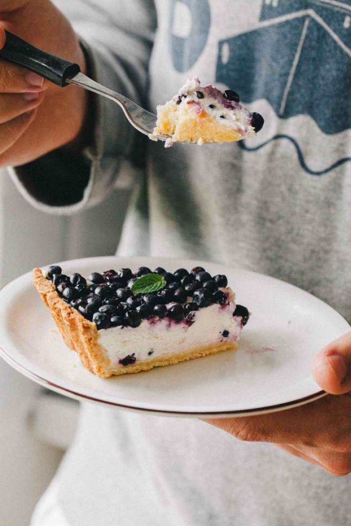 Slice of Homemade Blueberry Tart with Light Yogurt Cream