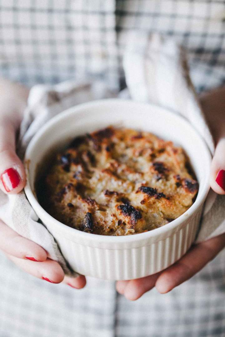 Baked bread stuffing in a bowl held in hands