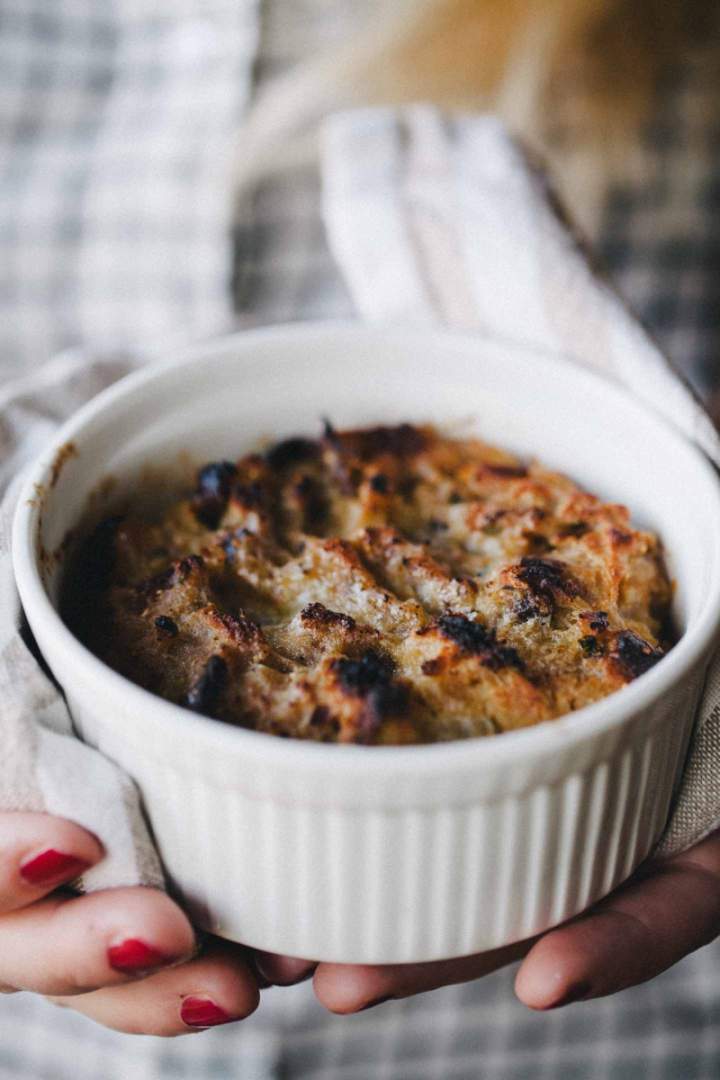 Baked bread stuffing in a bowl held in hands