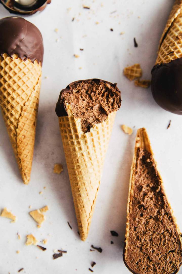 Creamy and Airy Chocolate Swiss Meringue Buttercream Filled Cones, dipped in chocolate