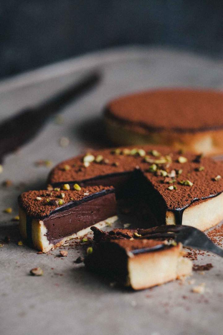 Chocolate tart with a silky cacao glaze and pistachios