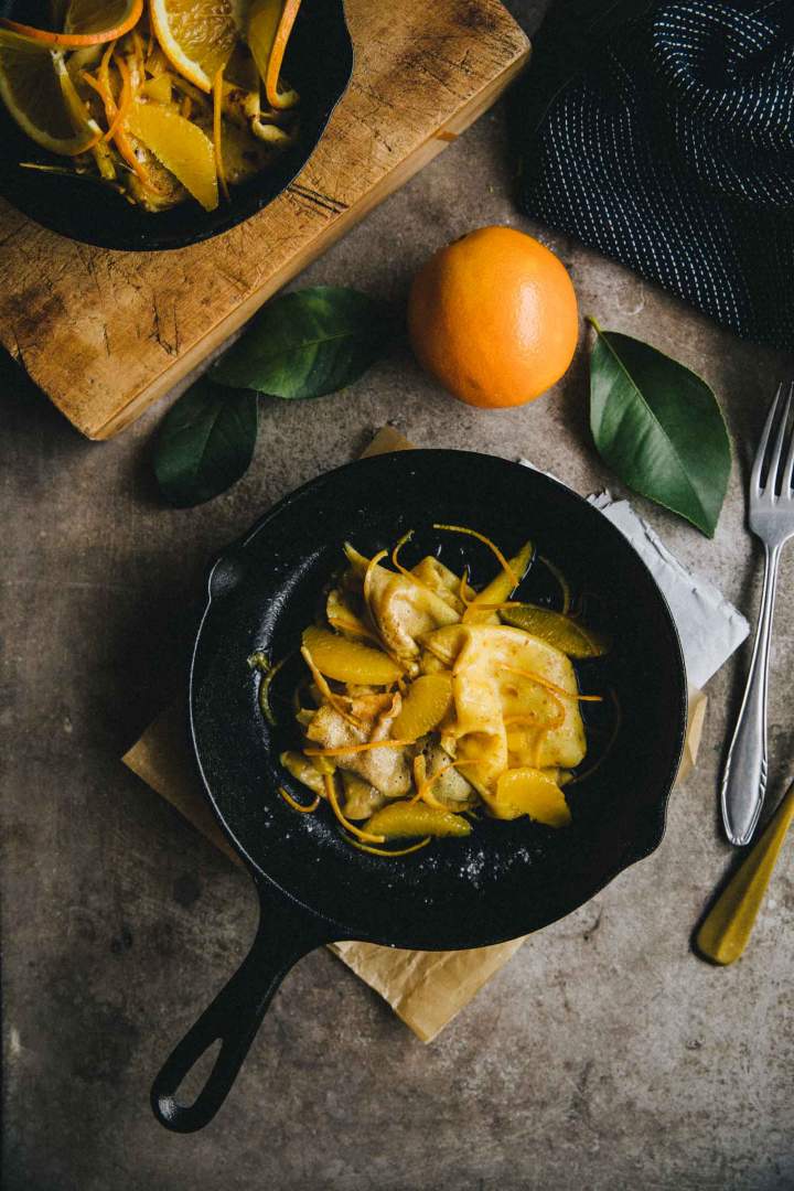 Crêpes with silky orange sauce served in a skillet