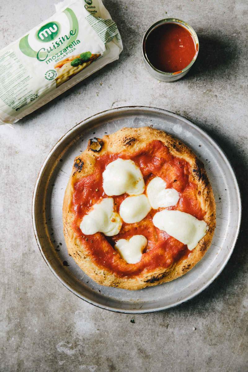 Fried pizza dough with tomato sauce and melted mozzarella cheese