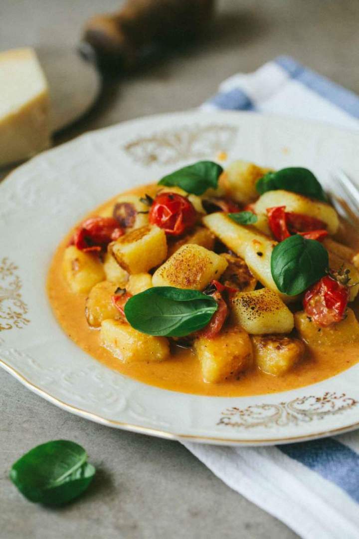 Gnocchi with Cherry Tomatoes served with basil on a plate