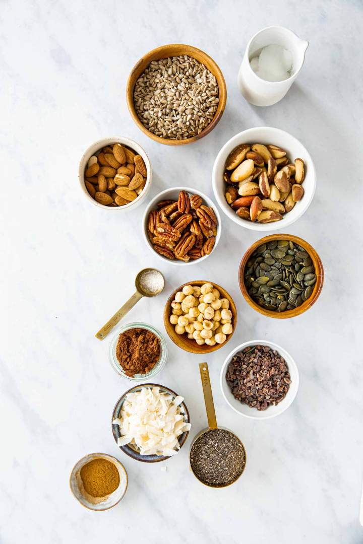 Ingredients for a homemade keto granola, seeds, nuts, coconut, cocoa