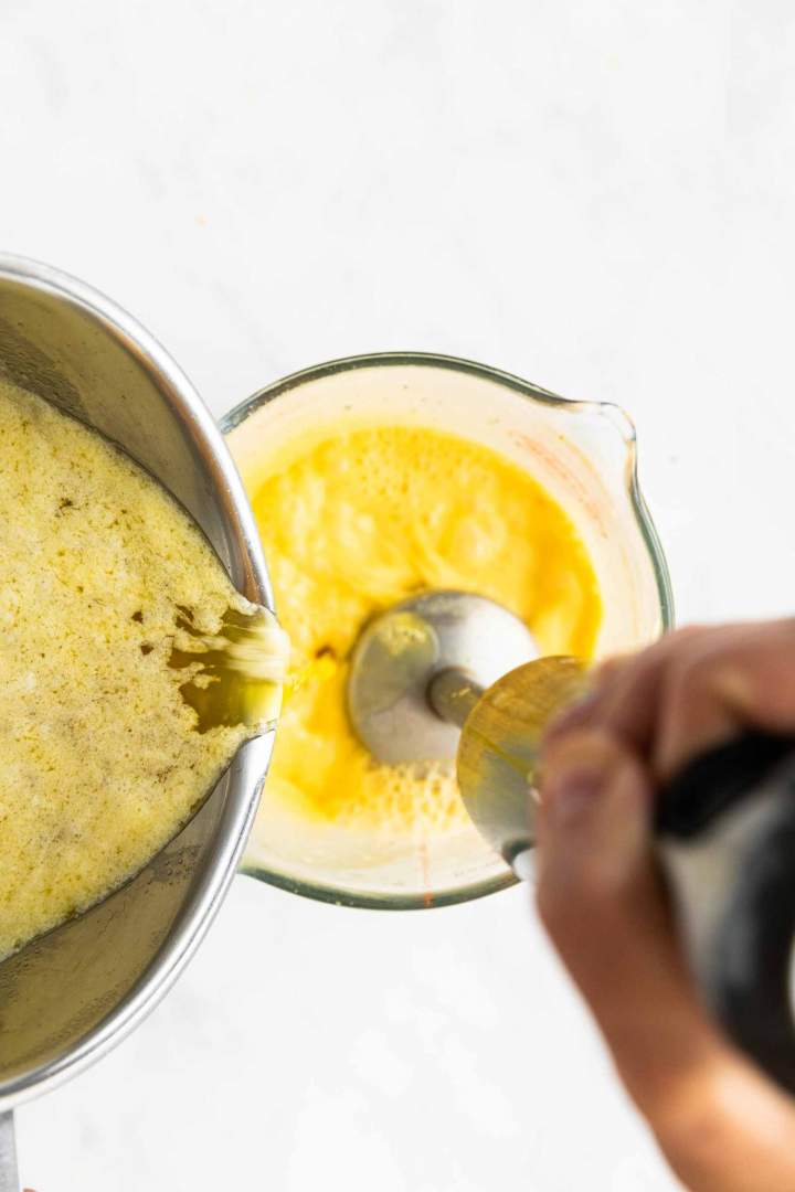 adding hot butter to eggs for Hollandaise Sauce