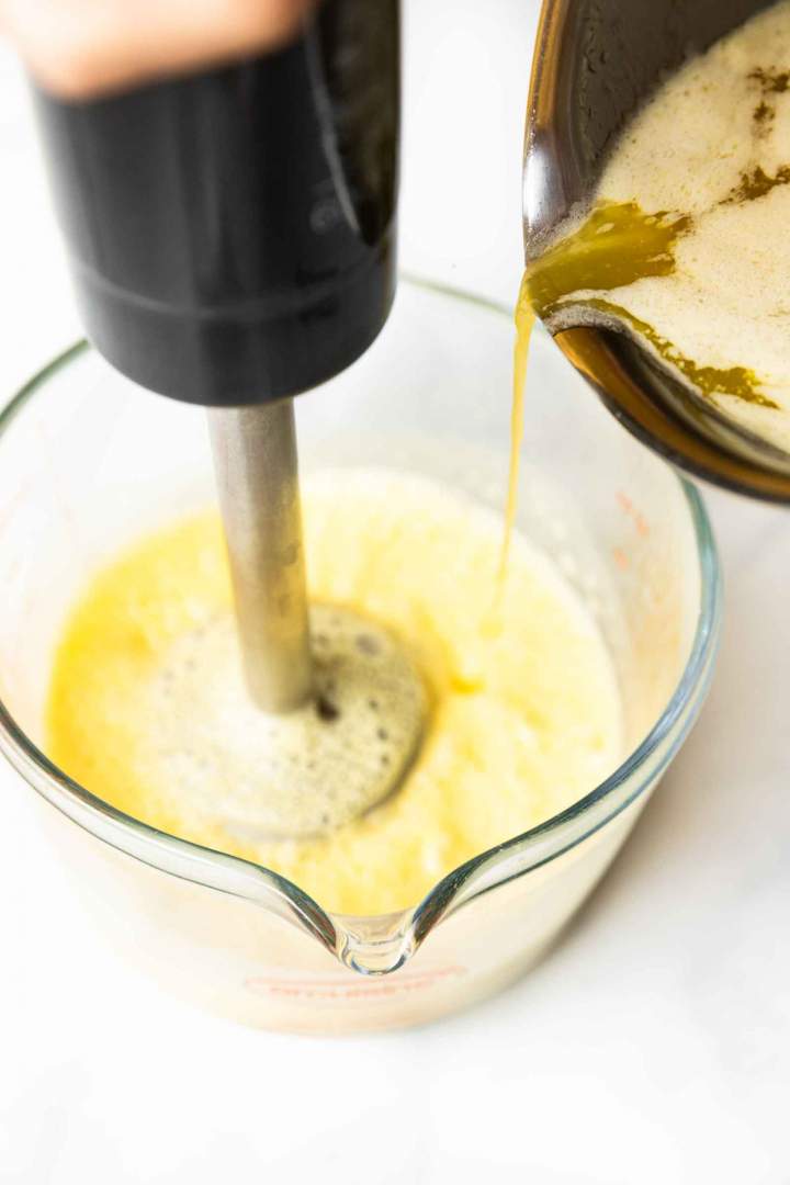 adding hot butter to eggs for Hollandaise Sauce