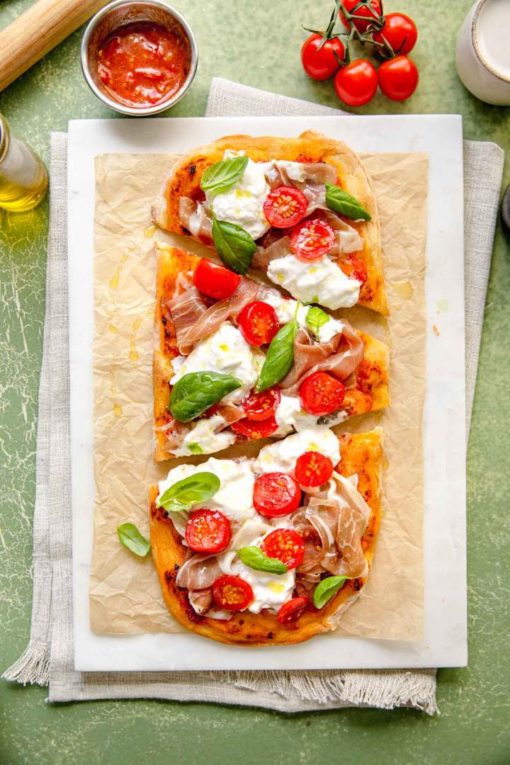 Pinsa with Prosciutto, Tomato, and Burrata