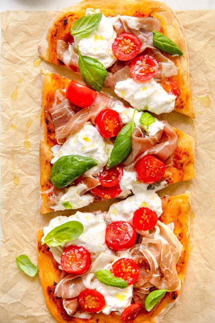 Pinsa with Prosciutto, Tomato, and Burrata