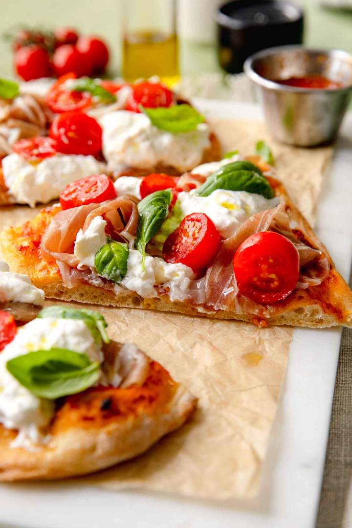 Pinsa with Prosciutto, Tomato, and Burrata