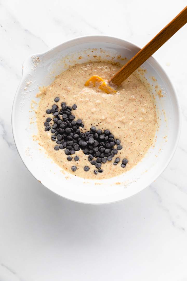 Adding chocolate chips to the batter for Banana Chocolate Chip Pancakes
