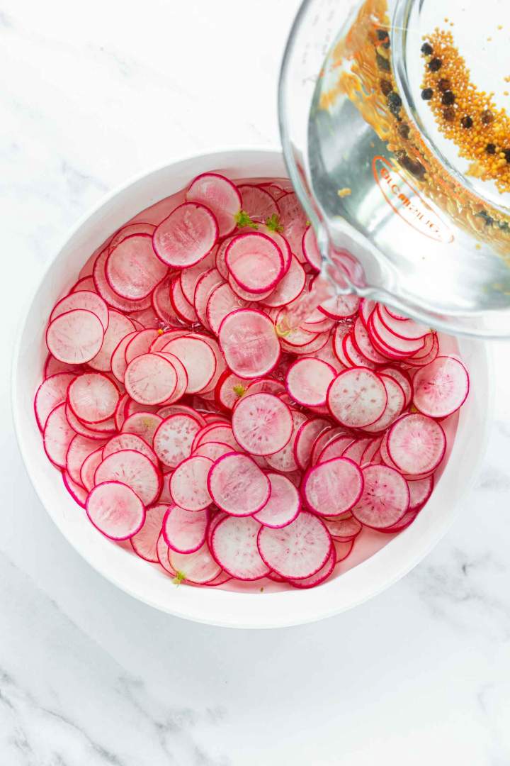 Covering the radishes with liquid for Quick Pickled Radishes