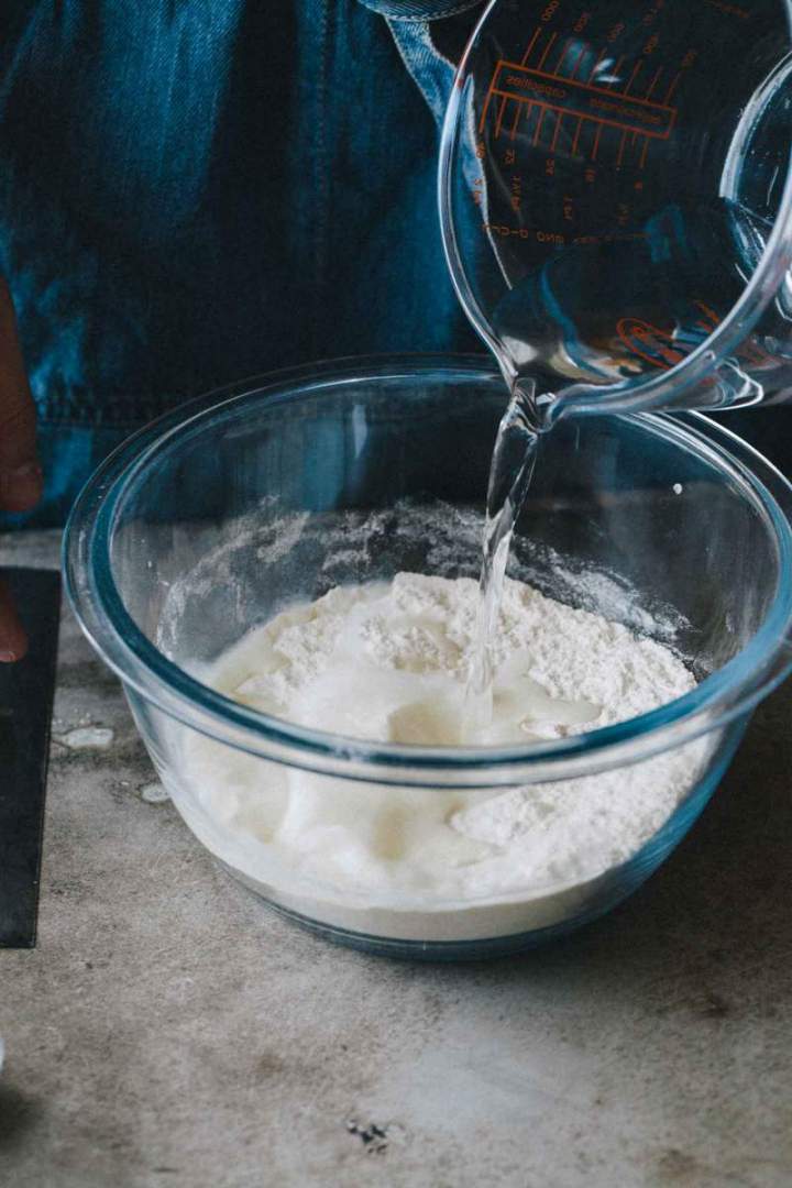 Combined water and flour in a bowl for Quick pizza dough (crust)