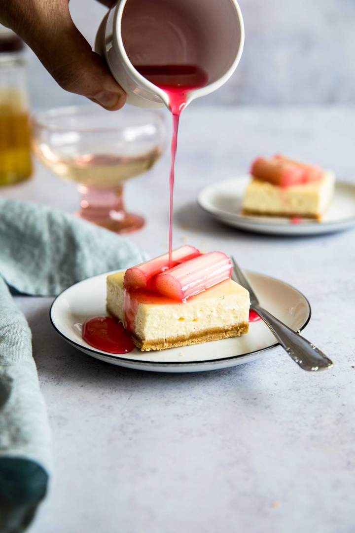 Drizzling vanilla cheesecake bars with rhubarb syrup