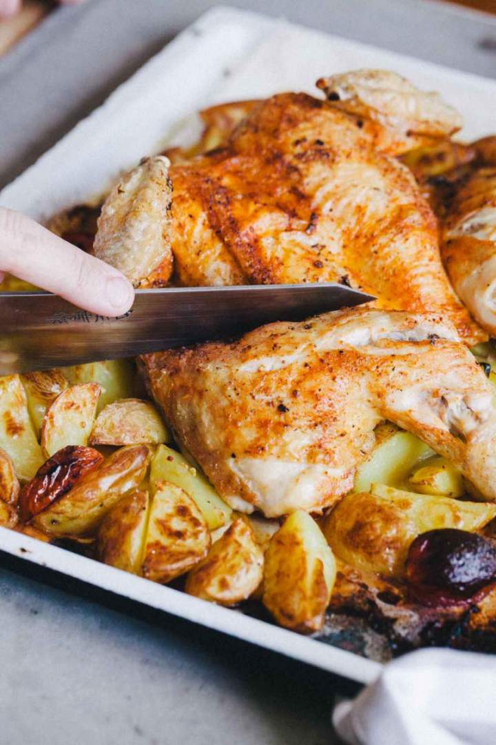 Baked Roast chicken with new potatoes served on a tray