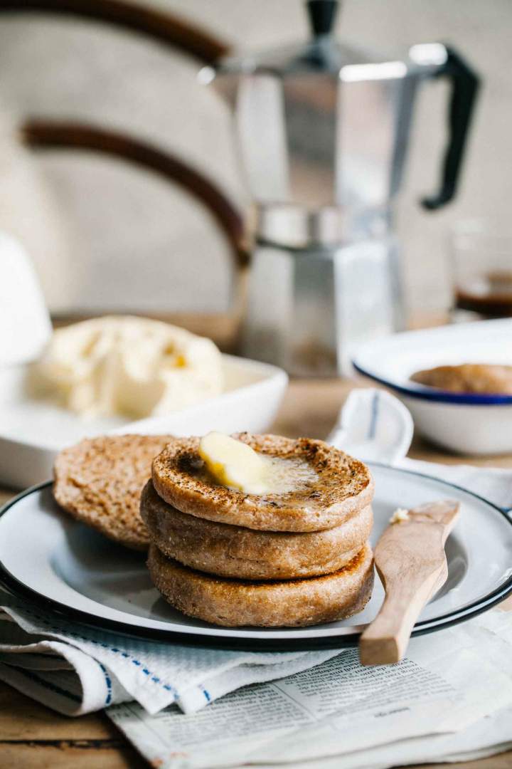 Spelt english muffins freshly baked and spread with butter