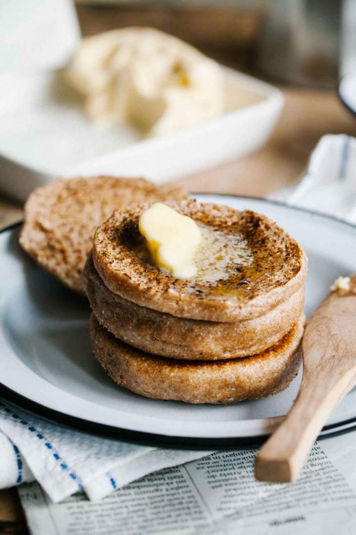 Spelt english muffins freshly baked and spread with butter