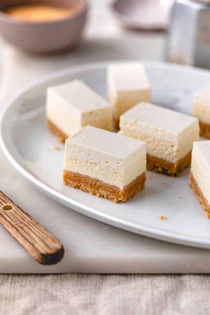 Sour Cream–Topped Cheesecake Slices feature three delicious layers — a crisp cookie base, a smooth farmer’s cheese filling, and a silky sour cream topping.  Sour Cream Topped Cheesecake Slices