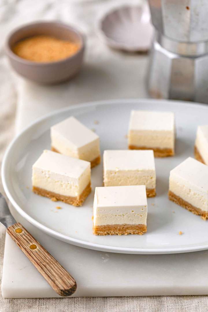 Sour Cream–Topped Cheesecake Slices feature three delicious layers — a crisp cookie base, a smooth farmer’s cheese filling, and a silky sour cream topping.  Sour Cream Topped Cheesecake Slices