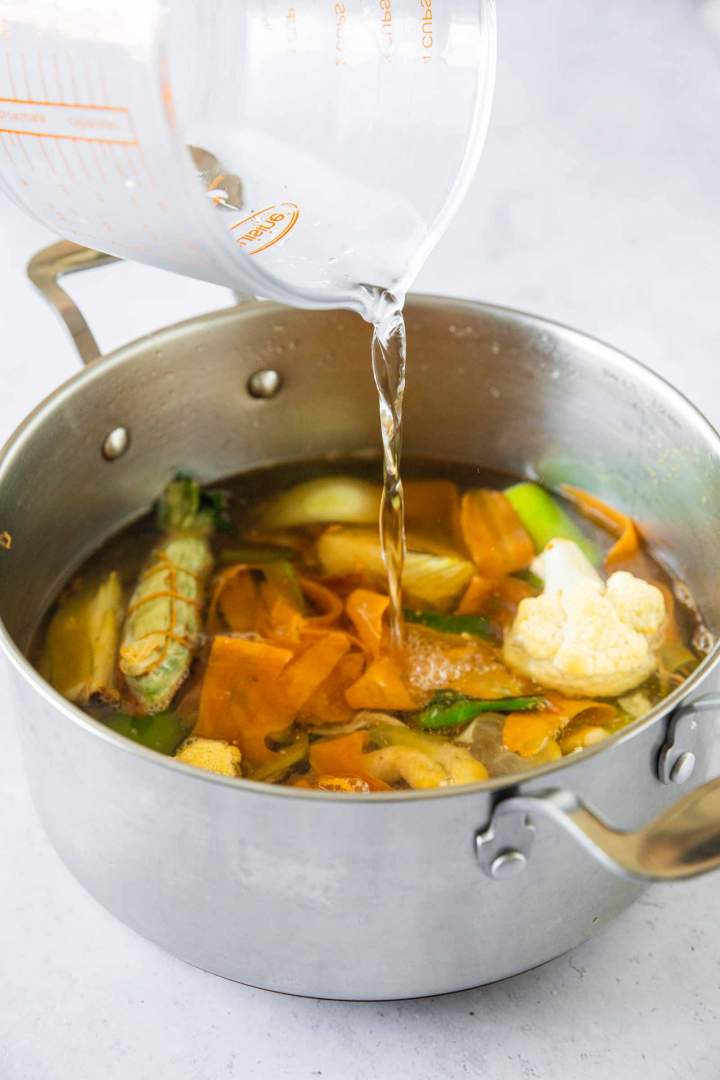 Pouring water over the vegetables for vegetable stock